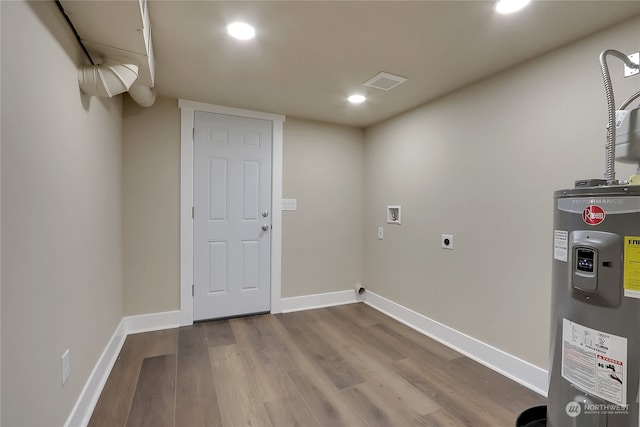 laundry area with washer hookup, dark wood-type flooring, electric dryer hookup, and electric water heater