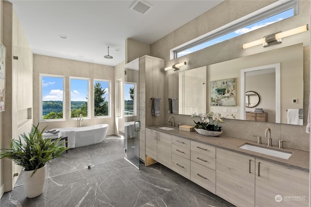 bathroom with backsplash, double vanity, a bathtub, and tile flooring