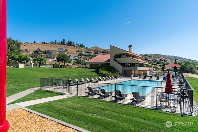 view of swimming pool featuring a patio and a lawn