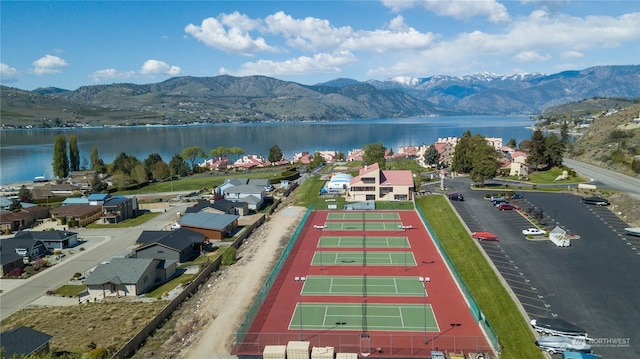 drone / aerial view featuring a water and mountain view