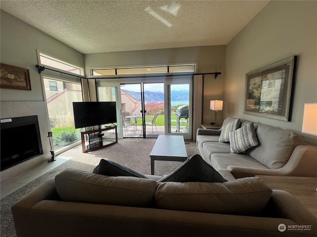 living room with plenty of natural light, light carpet, and a textured ceiling