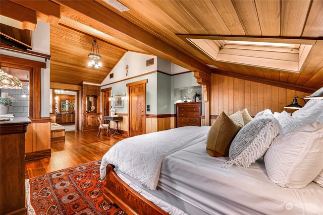 bedroom with wood-type flooring, vaulted ceiling with skylight, wood walls, and wood ceiling