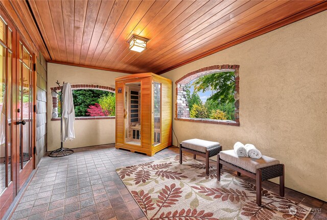 living area featuring tile floors and wood ceiling