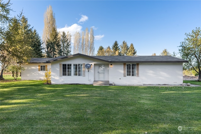 rear view of property with a lawn