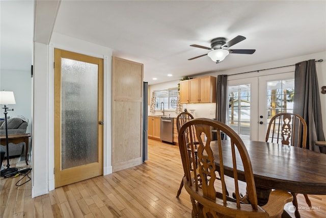 dining room featuring a wealth of natural light, french doors, ceiling fan, and light hardwood / wood-style floors