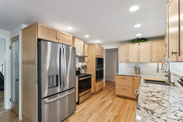 kitchen with light brown cabinets, backsplash, light hardwood / wood-style flooring, stainless steel appliances, and sink