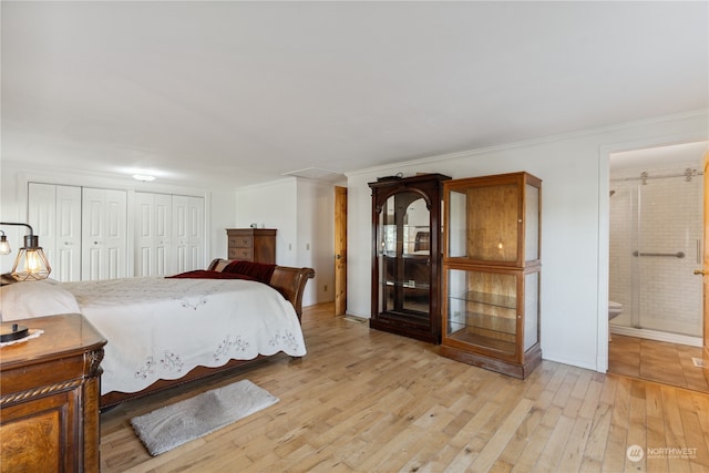 bedroom featuring connected bathroom, light tile flooring, and multiple closets