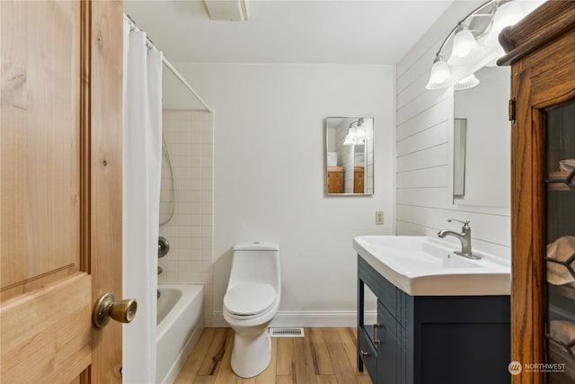 full bathroom with hardwood / wood-style flooring, toilet, shower / bath combination with curtain, and large vanity