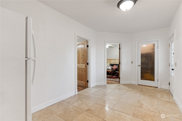 hall with light tile flooring