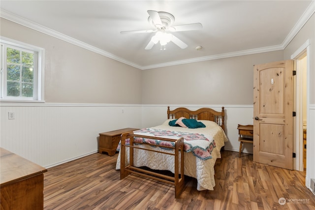 bedroom featuring hardwood / wood-style floors, ceiling fan, and crown molding