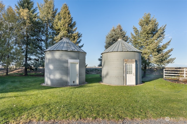 view of outdoor structure featuring a lawn