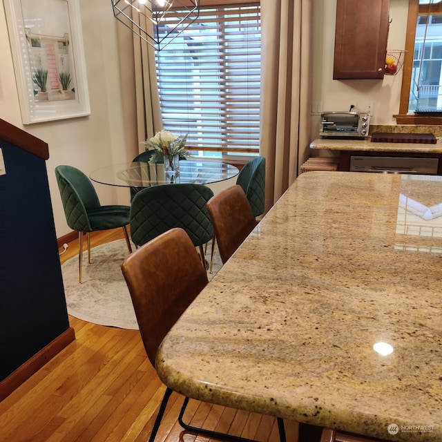 dining room with light hardwood / wood-style floors and a chandelier