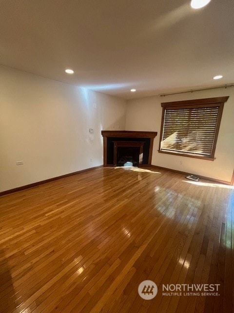 unfurnished living room with hardwood / wood-style floors