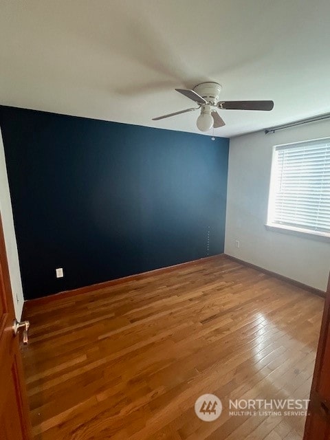 empty room with ceiling fan and light wood-type flooring