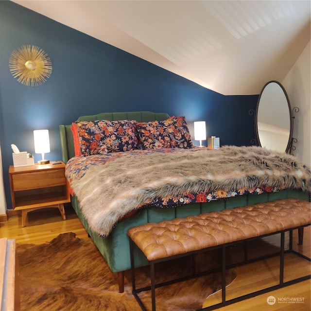 bedroom with light hardwood / wood-style flooring and lofted ceiling