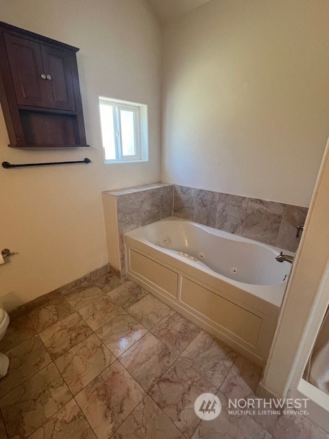 bathroom featuring a bath and tile flooring