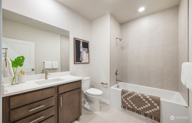 full bathroom featuring tile patterned floors, tiled shower / bath, vanity, and toilet