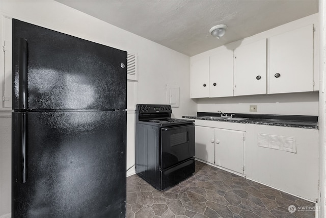 kitchen featuring white cabinetry, sink, and black appliances