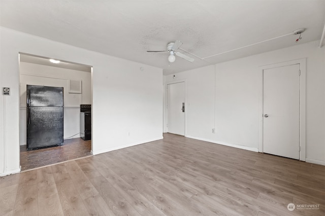 unfurnished room with ceiling fan and light hardwood / wood-style flooring