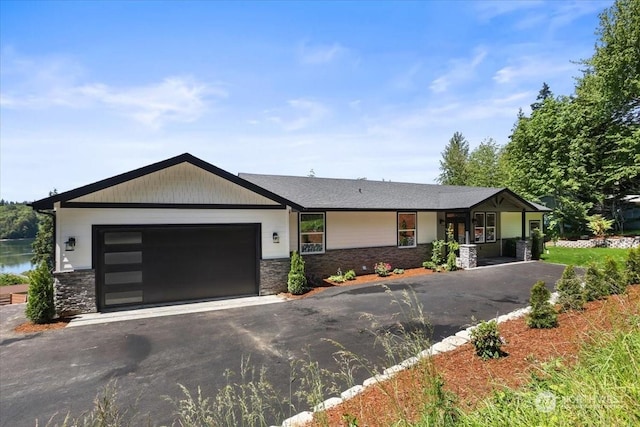 view of front facade with a water view and a garage