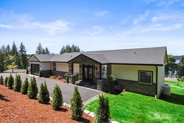 single story home featuring french doors and a front lawn