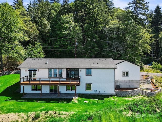 rear view of property with a yard, a patio, a deck, and central AC unit