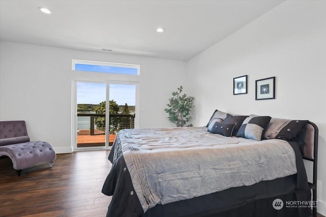 bedroom with dark hardwood / wood-style floors and access to exterior