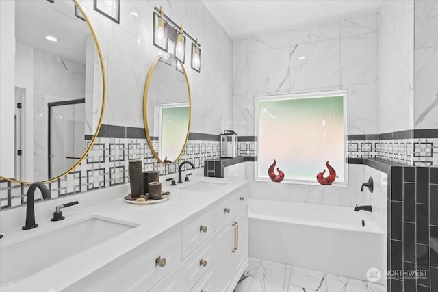 bathroom with decorative backsplash, vanity, tile walls, and plus walk in shower