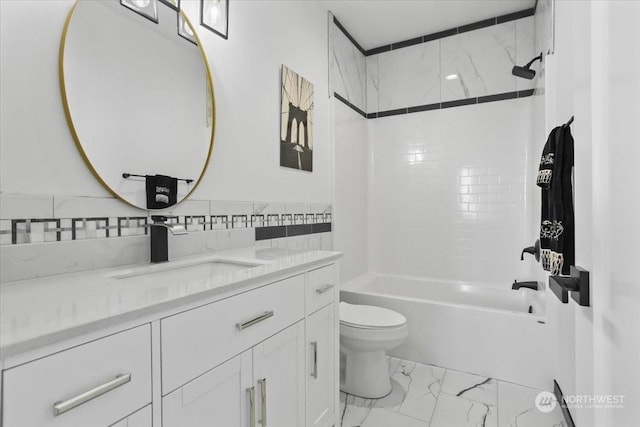 full bathroom featuring toilet, vanity, tile walls, and tiled shower / bath