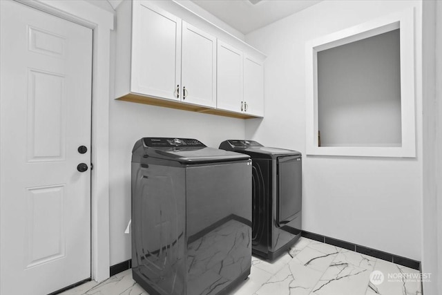 laundry area featuring cabinets and washing machine and clothes dryer