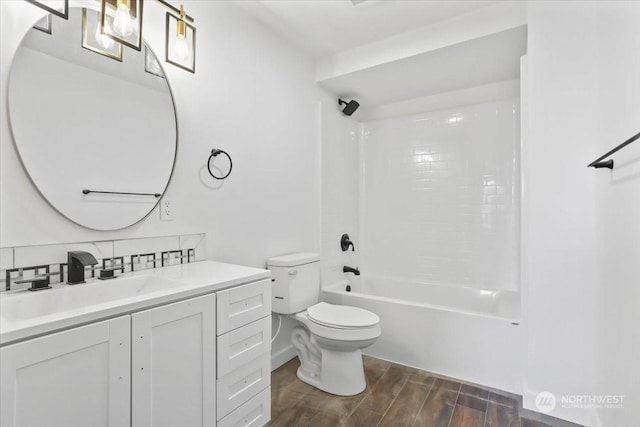 full bathroom featuring decorative backsplash, vanity, toilet, and shower / washtub combination