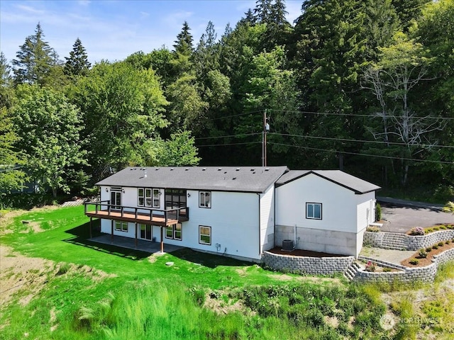 rear view of property featuring a patio area, a yard, central AC unit, and a deck