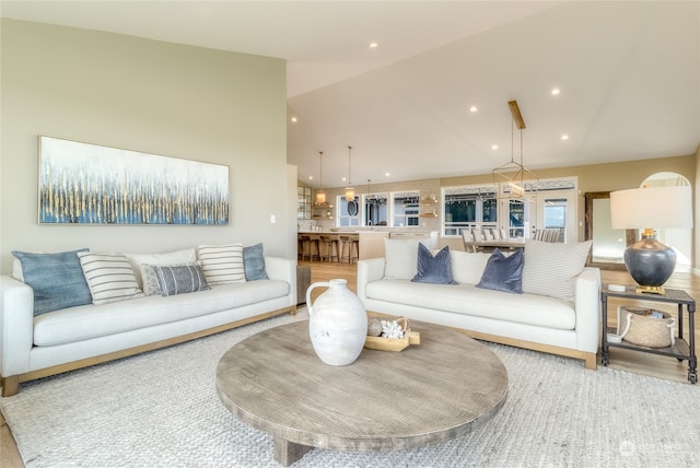 living room featuring lofted ceiling