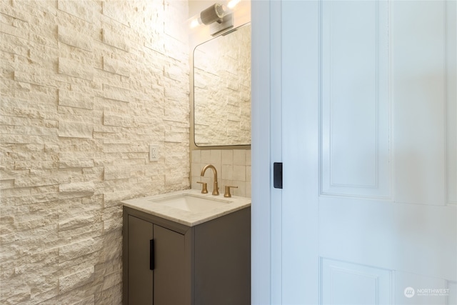 bathroom featuring vanity and decorative backsplash