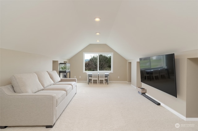 living room with light colored carpet and vaulted ceiling