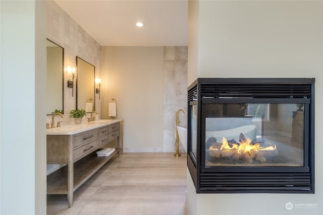 bathroom with vanity and a multi sided fireplace