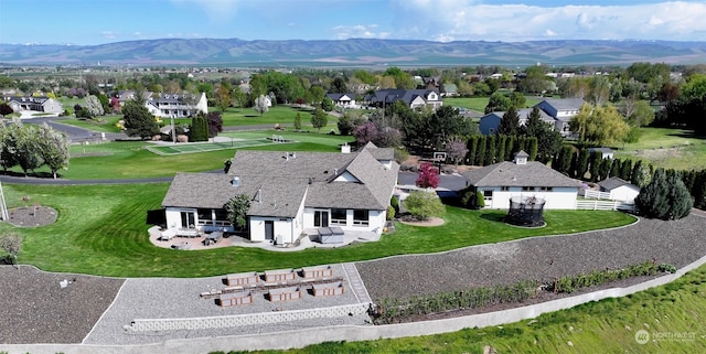 birds eye view of property with a mountain view