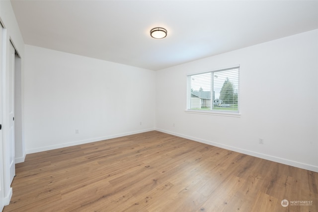 unfurnished room featuring light wood-style floors and baseboards