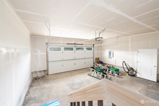 garage featuring a garage door opener and electric panel