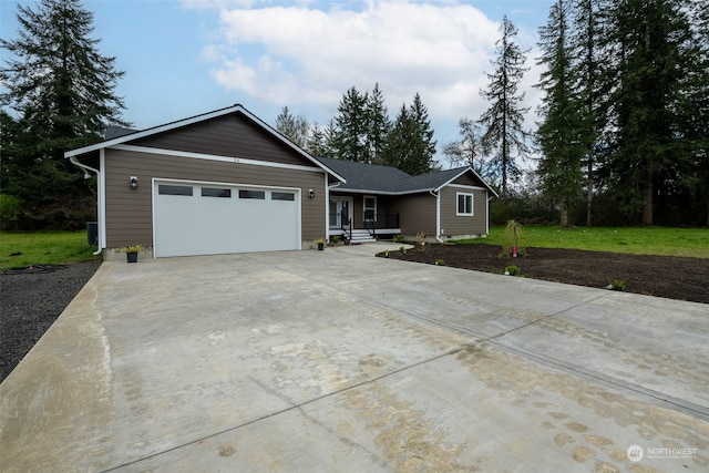 single story home with a garage and a front yard