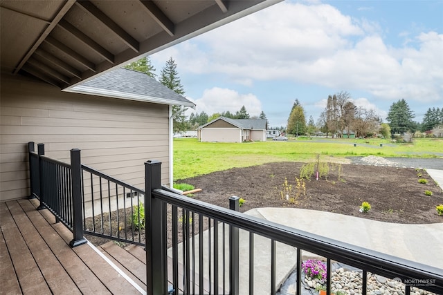 wooden deck featuring a lawn