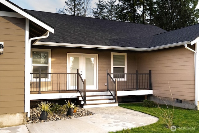 doorway to property with crawl space, covered porch, and a shingled roof