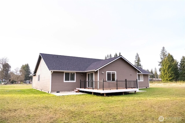 back of house with crawl space, a lawn, a shingled roof, and a wooden deck