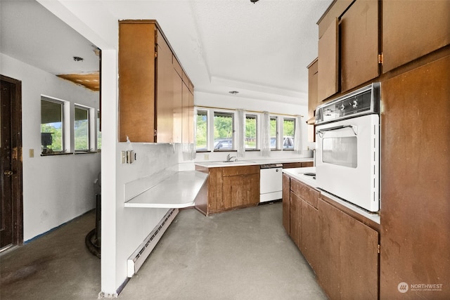 kitchen with a textured ceiling, sink, a baseboard radiator, and white appliances