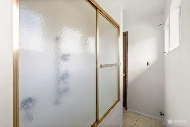 bathroom featuring tile patterned floors and a shower with door