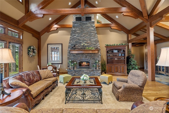 living room with a fireplace, high vaulted ceiling, beamed ceiling, and hardwood / wood-style flooring