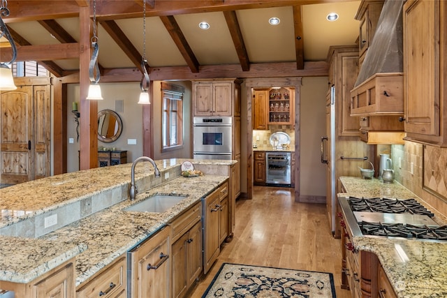 kitchen featuring stainless steel appliances, wine cooler, tasteful backsplash, and sink