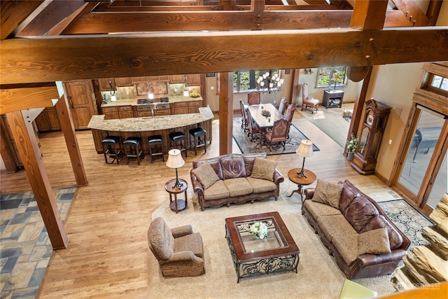 living room featuring beam ceiling and light hardwood / wood-style floors