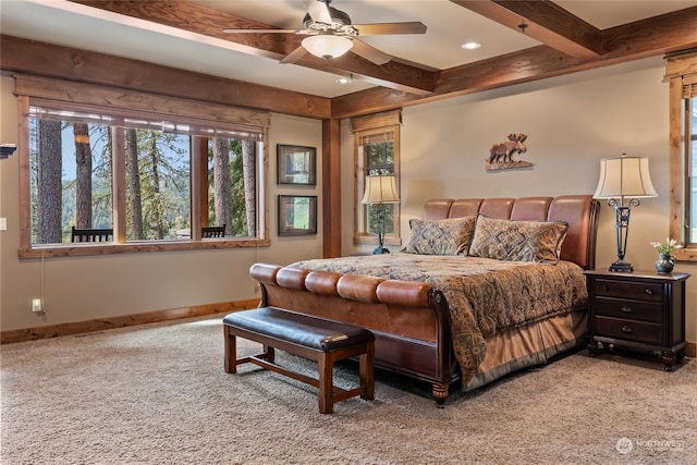 carpeted bedroom featuring beam ceiling and ceiling fan