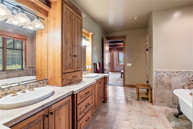 bathroom with a washtub and vanity